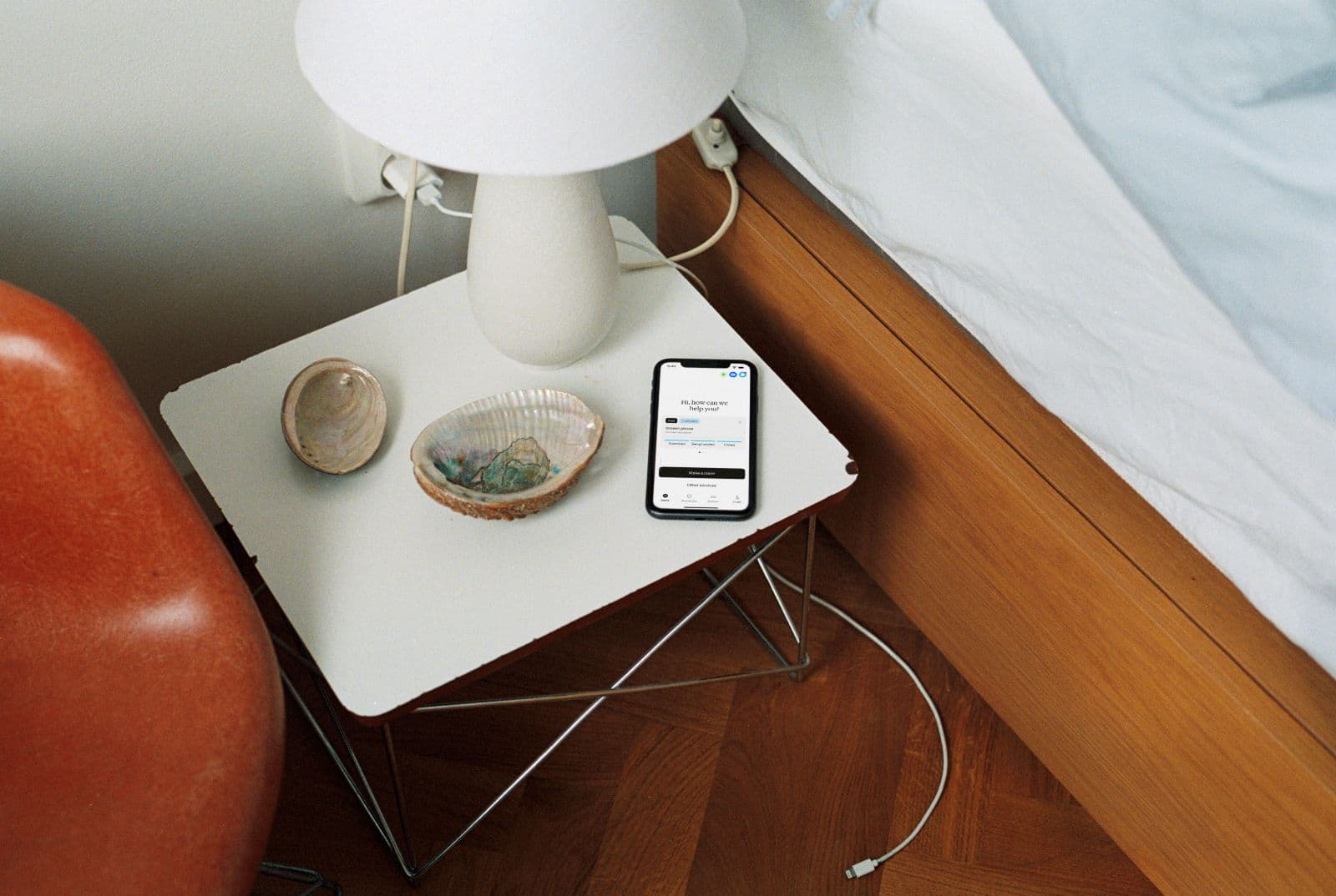 Phone on bedside table in bedroom.