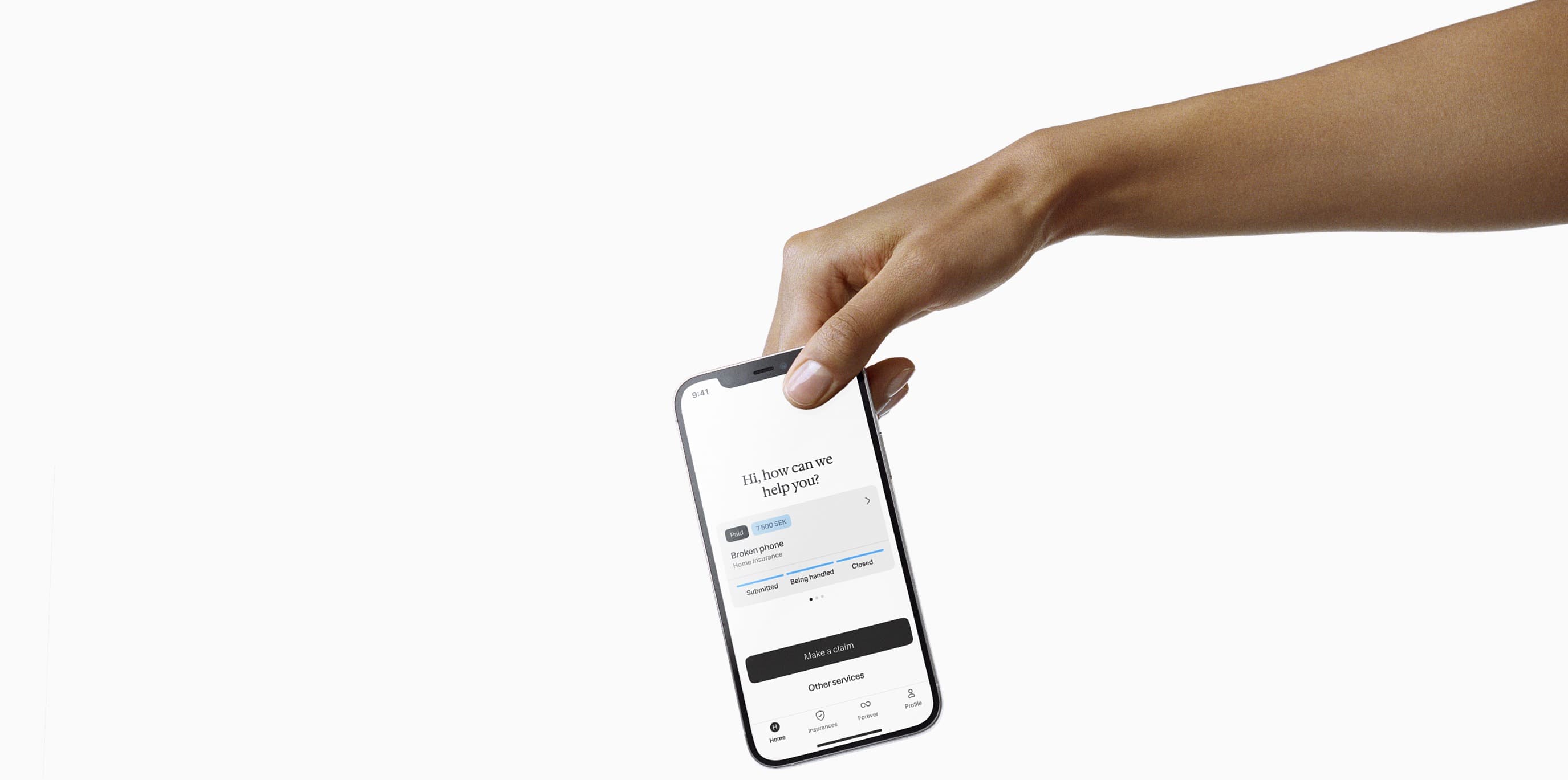 A mobile phone with Hedvig insurance app held by hand.